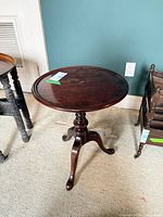 Full view of round side table with pedestal and tripod legs