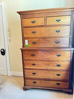 Front view of two-piece wooden dresser showing arrangement of eight drawers