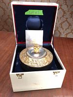 Bowl in open presentation box showing interior lining and accessories