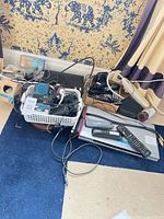 Overview of lot showing Sony DVD player, remote, telephones, basket of electronics and cables