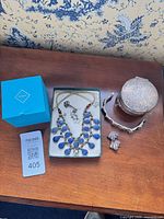 Overall lot view showing jewellery pieces and Birks box