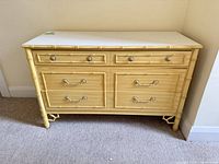 Front view showing six drawers, faux bamboo trim, hardware, overall finish