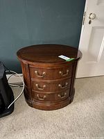 Front view showing three drawers and brass pulls