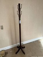 Full view of standing wood coat tree