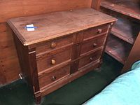 Front view of wood dresser showing drawers and knobs