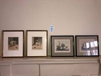 Four framed prints on mantel