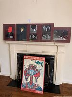 Group shot of all framed pieces leaning on fireplace