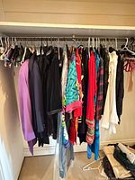 Closet rod showing full assortment of garments on hangers