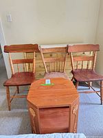 Side table front with three chairs behind