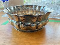 side view showing paneled hammered body and tarnish