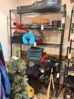 Full view of metal wire shelving unit with contents for scale