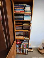 Full view of tall bookcase filled with books