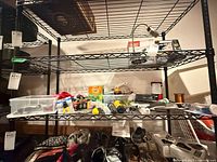 Shelving with flashlights, OFF insect repellent, copper wire spool, bungee cords and other small tools