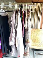 Clothing rack with assorted garments on hangers