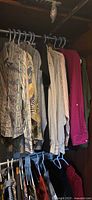 Assorted shirts and blouses hanging in closet