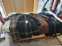 Four coats laid out showing fronts and patterns