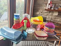 overview of assorted plastic kitchenware on metal rack
