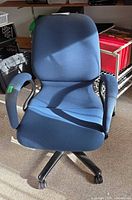 Front view of navy blue swivel chair with arms and wheeled base