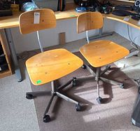 Front view of both matching swivel chairs under desk