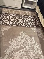 Two rugs showing overall ornate floral pattern and colors