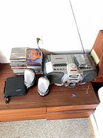 Sony CFD-G55 boombox with stack of CDs, JBL speakers, headphones, CD wallet