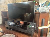 Front view of Toshiba TV on stand with accessories visible