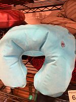 Blue neck pillow on shelf