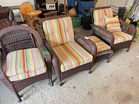 Overall view of four chairs and ottoman with striped cushions