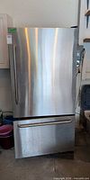 Front view of stainless steel GE bottom-freezer refrigerator