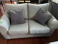 Front view of loveseat with two pillows