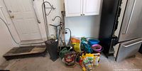 Overall view of lot showing tools, watering cans, planters, fertilizer bags