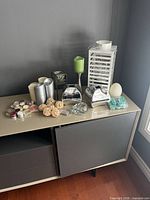 All items on console showing lantern, candles, holders, wax melts, rattan balls