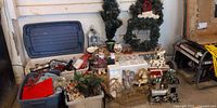 Wide view of lot showing wreaths, train, rocking horse, reindeer, artificial tree, lantern, mugs, totes of ornaments