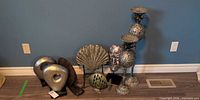 All eight metal decorative pieces grouped against wall