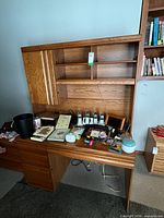 Front view of desk showing work surface, drawers, hutch shelves, cabinet