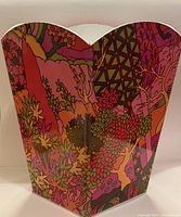 Overall view of waste basket showing psychedelic graphics and scalloped rim