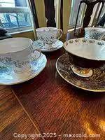 Multiple teacups with saucers on table