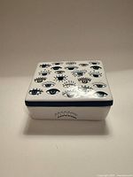 Closed trinket box showing top eye motif pattern