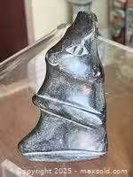 Side view of Inuit soapstone seal carving showing form and polish