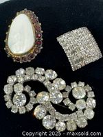 Group shot of all three brooches showing relative sizes and designs