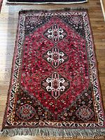 Full view of Persian rug showing overall pattern and size