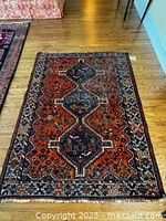 Full view of rug on wood floor