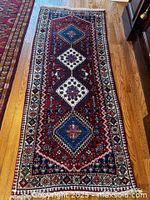 Full view of Persian runner rug on hardwood floor