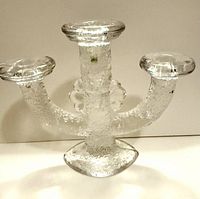 Front view of clear textured glass 3-arm Pukeberg candelabra
