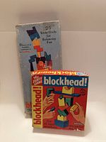 Front view of both boxed Blockhead games