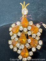 Front view of brooch showing amber teardrop stones and clear rhinestones