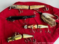 Five lures on red fabric