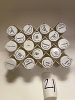 Front view of rack showing honeycomb pattern and labeled jar lids