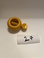 Top view of yellow round screw nutcracker