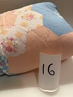 Rolled quilt edge displaying pattern and fabric prints